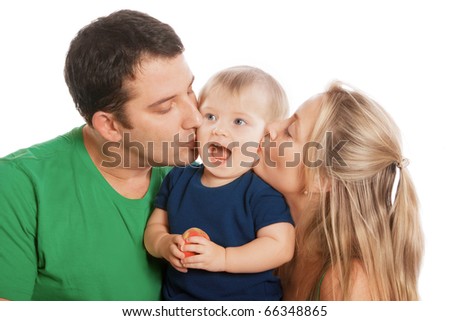 Portrait of beautiful young parents kissing happy child