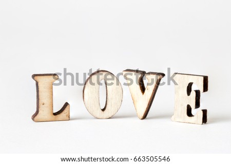 wooden word "love" on white background