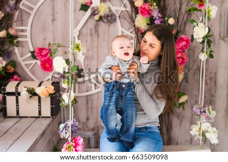 Beautiful mother holding baby boy, mom carry cute child adorable small son, happy family picture, happiness concept