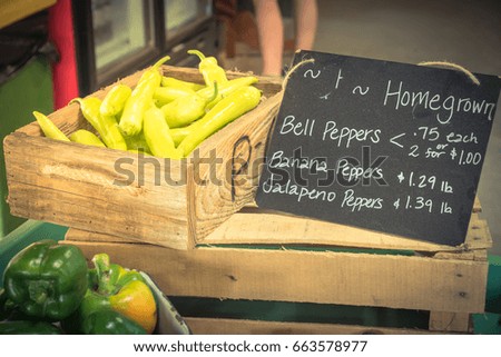 Full baskets & crates of bell peppers, banana peppers and Jalapeno peppers with price tags on display at local farm store in Texas, US. Fresh picked and organic produce for sale at farmer market.