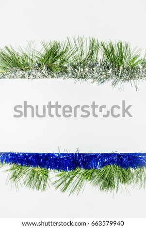 Vertical Christmas background. Holiday banner or poster design with blue and silver decoration on green pines. White horizontal copy space for text