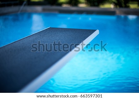 Closeup view of diving board in swimming pool