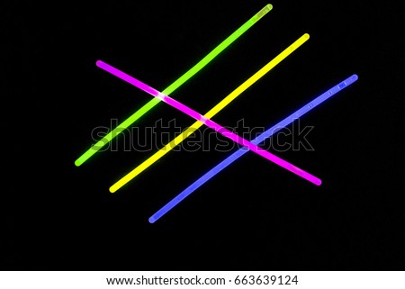 Glow sticks neon light fluorescent on back background. variation of different colored chem lights
