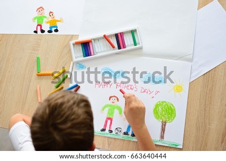 Child drawing a card for daddy for father's day