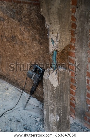 Jackhammer resting by the ruined wall