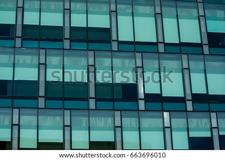 Window Patterns II: Drawn shades create patterns in the tinted windows. Royalty-Free Stock Photo #663696010