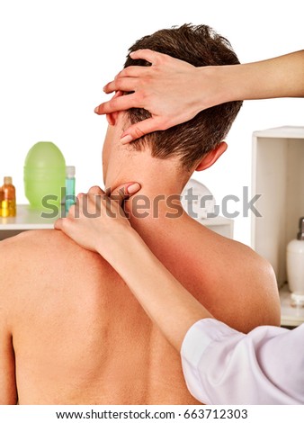 Shoulder and neck massage for woman in spa salon. Doctor making therapy in rehabilitation center . Reinforcement of joint in good clinic. Back view. Elimination of consequences of sports injuries.