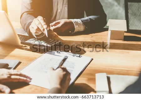Business Signing a Contract Buy - sell house.  Royalty-Free Stock Photo #663713713