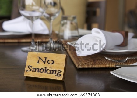 wooden no smoking sign on wood dining table in restaurant