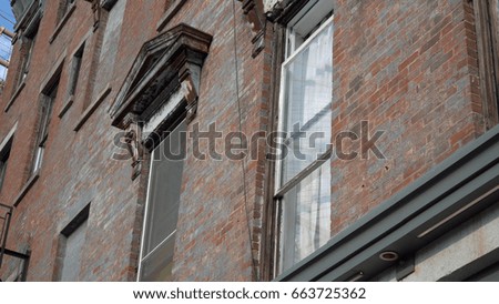 Close up exterior DX establishing photo of old vintage architecture style apartment building window day time outside. Brooklyn tenement style architecture design construction 