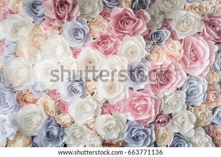 Backdrop of colorful paper roses background in a wedding reception with soft colors.
