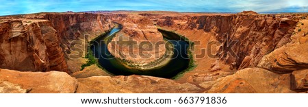 Panorama of Horseshoe Bend, Page Arizona.  The Colorado River and a land mass made of orange sandstone.  Made of twenty-three images, not one hundred percent accurate for perspective. Royalty-Free Stock Photo #663791836