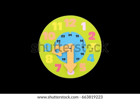 8.30 (half past eight) O'clock round toy clock isolated on black background