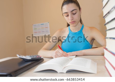 Student, Young Girl working on his homework. Education concept - books on the desk