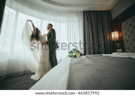 The bride and groom on the window background