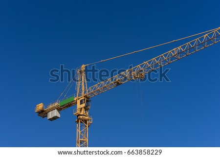 photo of Construction crane and building with blue sky background