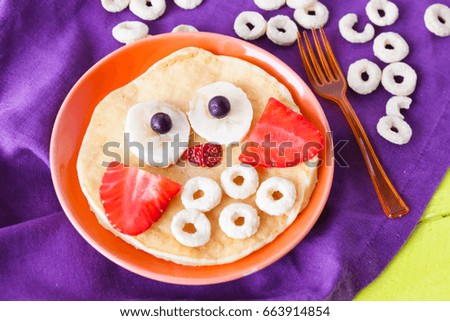 Children's breakfast, pancake owl with strawberries and bananas