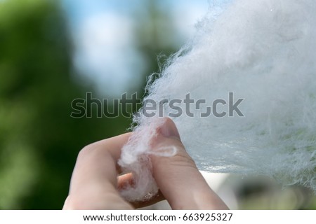 Candy-floss with woman hand closeup