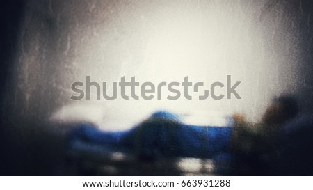 Patient lay down in the bed at hospital. Sick and coma. Blur picture and dark tone.