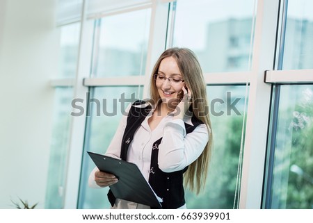 Portrait of businesswoman talking on a mobile phone in office