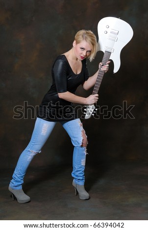 Pretty young female with white guitar