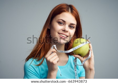  Diet, nutrition, apple woman with apple on a gray background                  