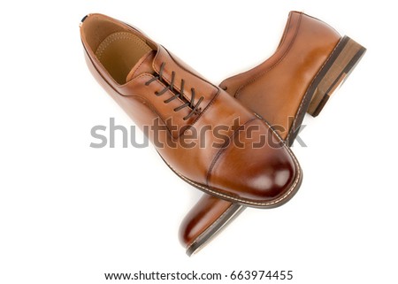 A pair of classic leather elegant shoes on a white background. Beautiful brown luxury and casual leather men shoes. Fashion accessory. Front view.