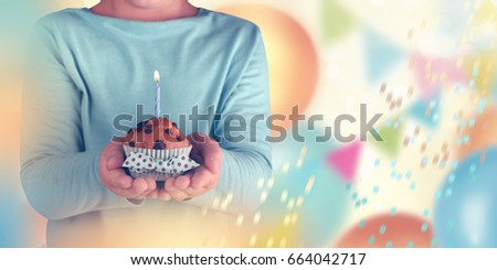 Kid boy holding birthday cake with candle, closeup
