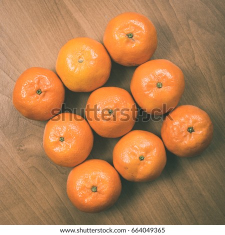 dish of oranges on wooden desk with. food pattern - vintage green effect