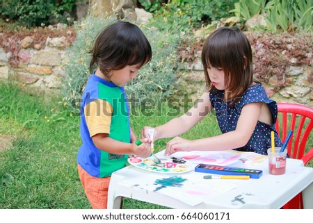 Happy kids painting .Activity outdoor in summer.
