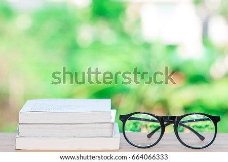 Glasses and books on wooden table.