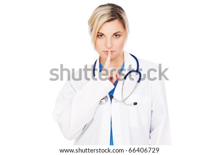 serious doctor making silence sign over grey background