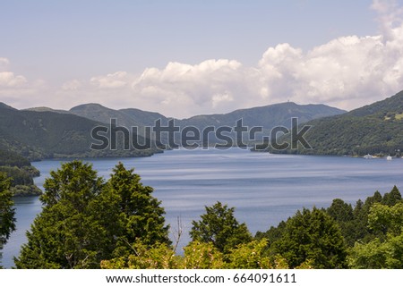 View of a lake behind trees, Lake Ashi, Hakone, Japan