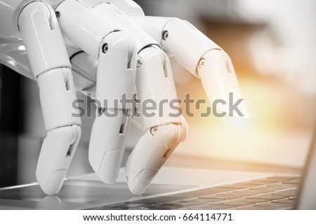 Robotic , artificial intelligence , robo advisor , chatbot concept. Robot finger point to laptop button with flare light effect. Royalty-Free Stock Photo #664114771