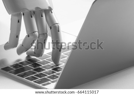 Chatbot , artificial intelligence , robo advisor , robotic concept. Robot finger point to laptop button. Royalty-Free Stock Photo #664115017