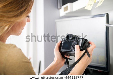 Freelance photographer woman at home office editing photos, empty camera screen