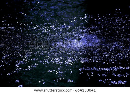 Dark blue background created from picture of water splash and spread from water surface.

