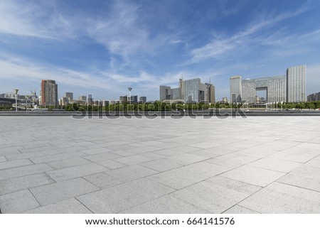 Panoramic skyline and buildings with empty concrete square floor
