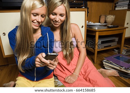 Sisters with cellphone