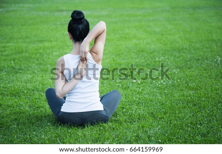 Young Woman Doing Yoga In The Park