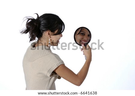 Cute young Hispanic looking into a mirror
