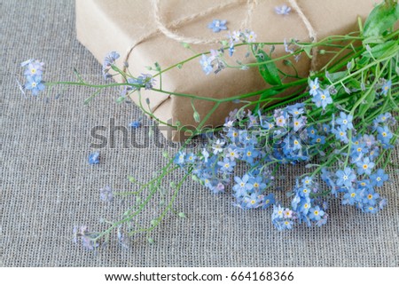 the gift box of flowers on fabric