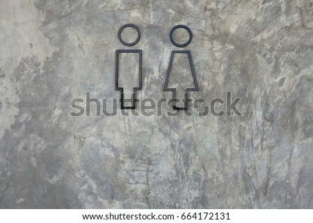 Toilet symbol on concrete wall background with copy space. Old grungy texture, grey concrete wall. Vintage brickwork backdrop or Pattern of modern brick wall