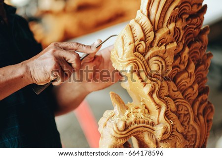 thailand men carve Phansa Big Candle for used during the Khao Phansa festival or The Buddhist Lent Day