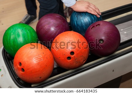 Large multi-colored bowling balls. The bowler chooses a ball