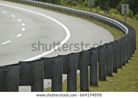Iron roadblocks at the corner of the highway. Royalty-Free Stock Photo #664194898