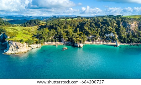 Aerial view on a small beach surrounded by rocks and forest. Coromandel, New Zealand
 Royalty-Free Stock Photo #664200727