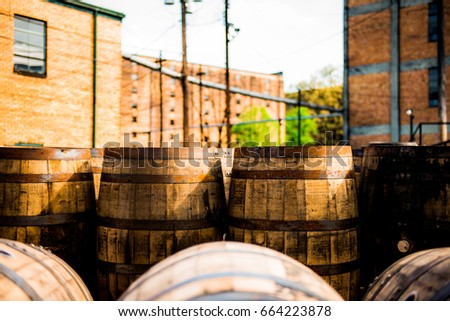 Rustic bourbon barrels at a Kentucky distillery on the Bourbon Trail.  Royalty-Free Stock Photo #664223878