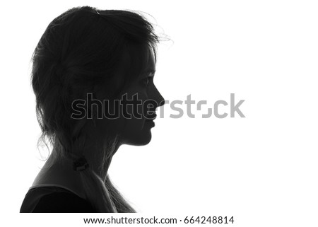 Black and white trendy portrait profile silhouette of face of a beautiful young woman with a hairdo on her head