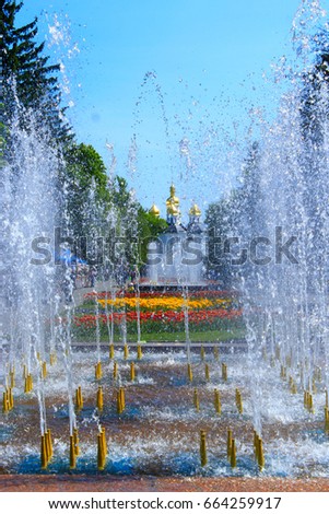people have a rest in city park with fountains in Chernihiv